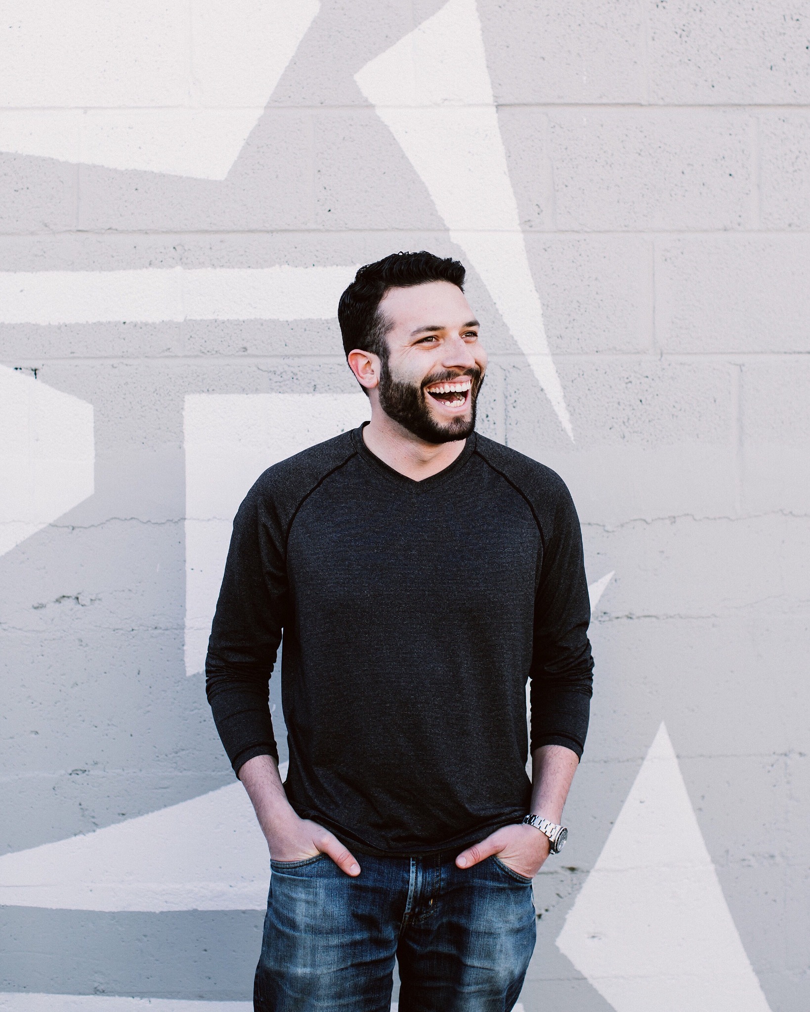 Matthew Brodeur smiling in front of a painted wall